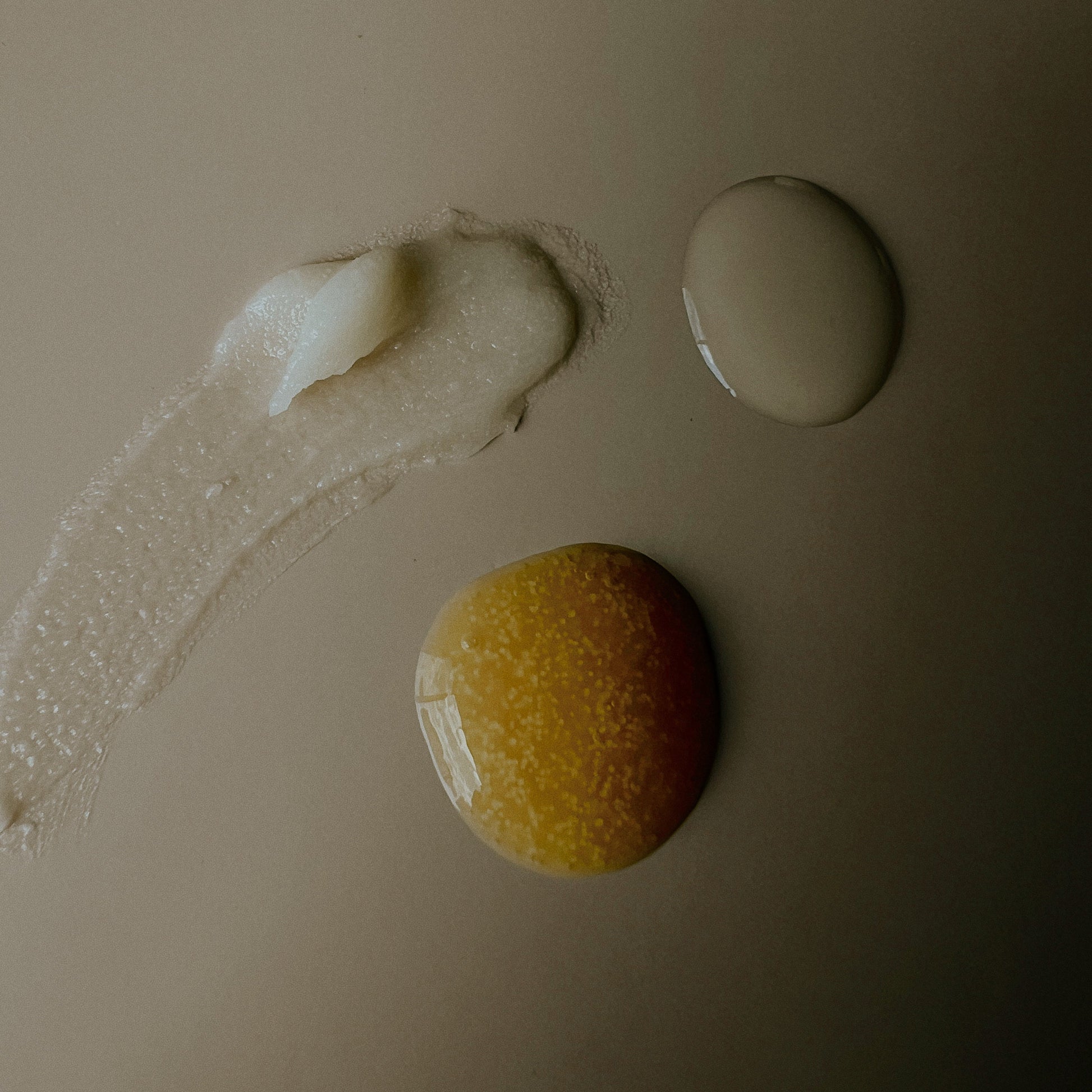 Three cosmetic products on a beige background