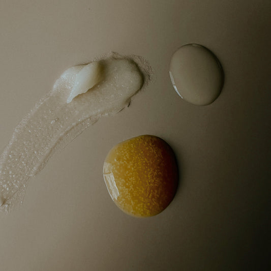 Three cosmetic products on a beige background