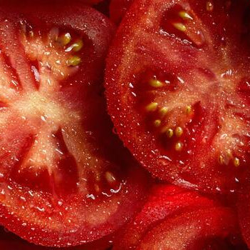 Close-up of sliced tomatoes with a focus on texture and color.