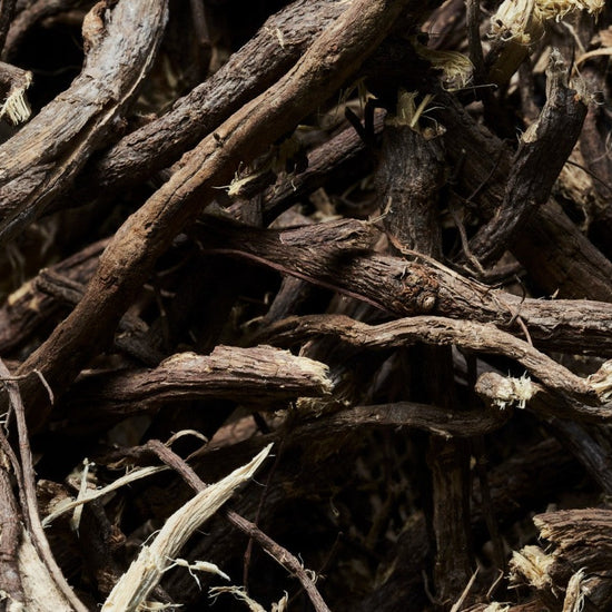 Close-up of dried herbs or roots with a dark brown color.